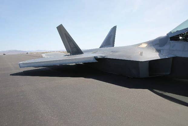 The F-22 sitting on Fallon's runway on its belly. (USAF mishap investigation photo)