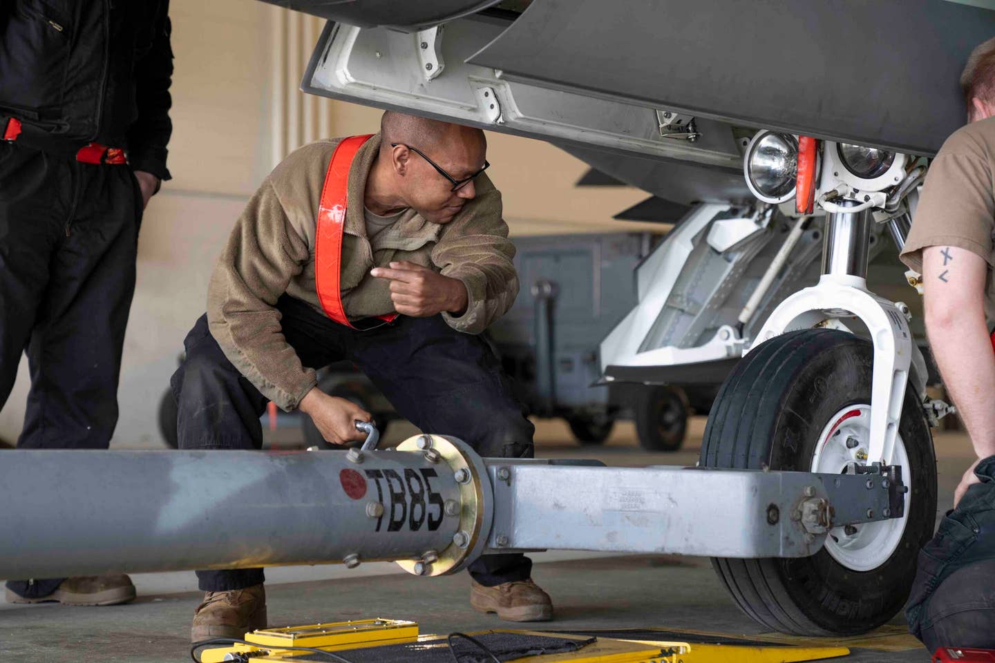 U.S. Air Force Tech. Sgt. Daniel Jefferson guides the F-22 onto balancing equipment during its rebalancing. <em>U.S. Air Force photo by Airman 1st Class J. Michael Peña</em>