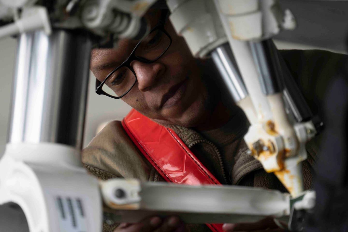 U.S. Air Force Tech. Sgt. Daniel Jefferson, an F-22 Raptor craftsman assigned to the 90th Aircraft Maintenance Unit, secures towing equipment during the rebalancing. <em>U.S. Air Force photo by Airman 1st Class J. Michael Peña</em>