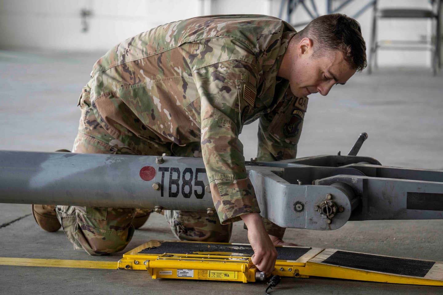 U.S. Air Force Tech. Sgt. Tyler Bowers, a quality insurance inspector assigned to the 3rd Maintenance Group, calibrates balancing equipment during the rebalancing test at Joint Base Elmendorf Richardson, Alaska, April 4, 2023. <em>U.S. Air Force photo by Airman 1st Class J. Michael Peña</em>