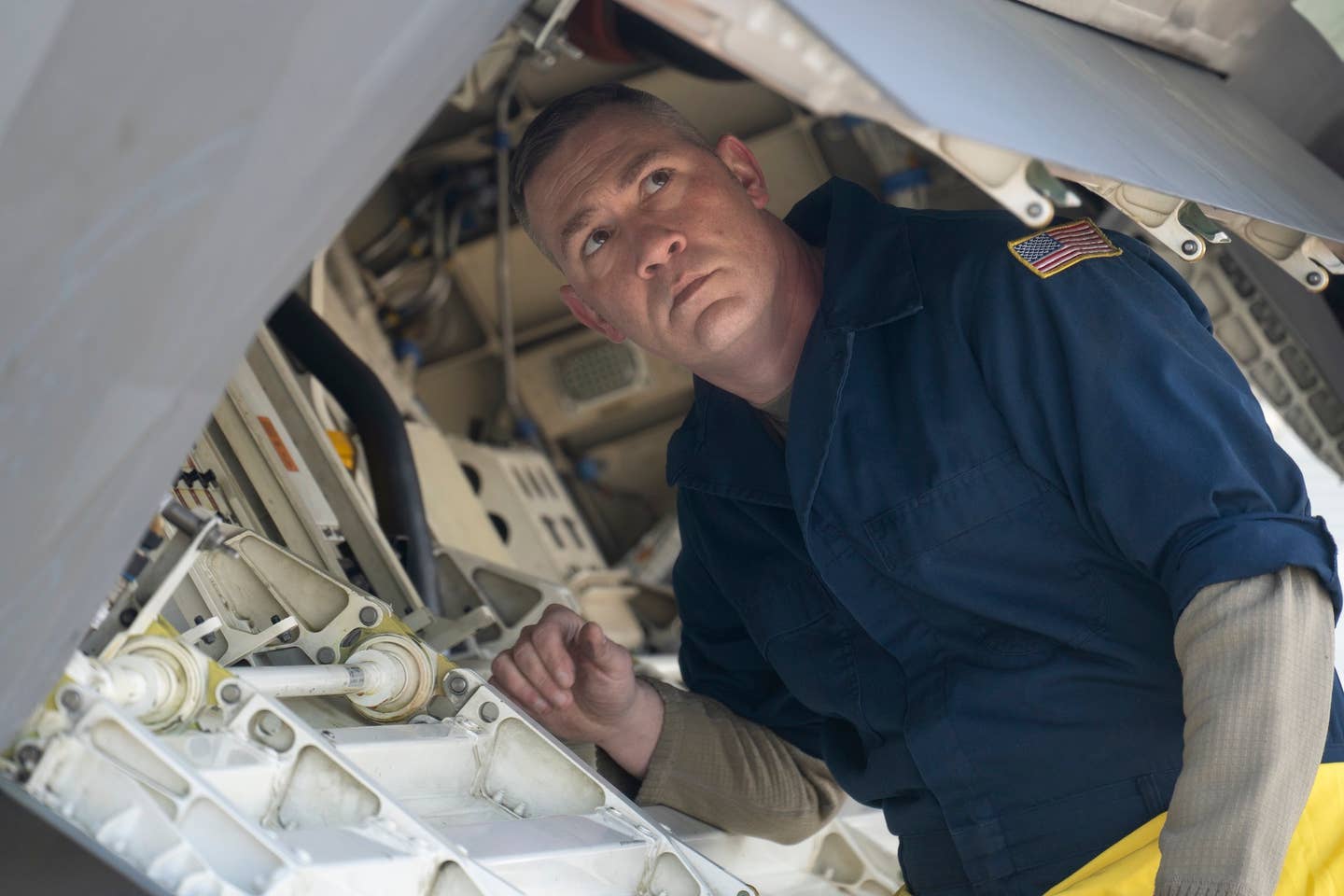 U.S. Air Force Master Sgt. Joshua Eller, an F-22 Raptor crew chief assigned to the 90th Air Maintenance Unit, inspects the aircraft. <em>U.S. Air Force photo by Airman 1st Class J. Michael Peña</em>