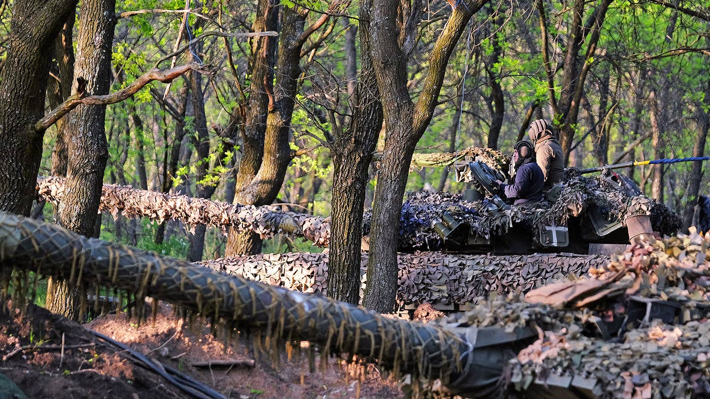 Ukrainian servicemen of the Adam tactical group ride a T-64 tank from a front line near the town of Bakhmut, Donetsk region, on May 7, 2023, amid the Russian invasion of Ukraine. (Photo by Sergey SHESTAK / AFP) 