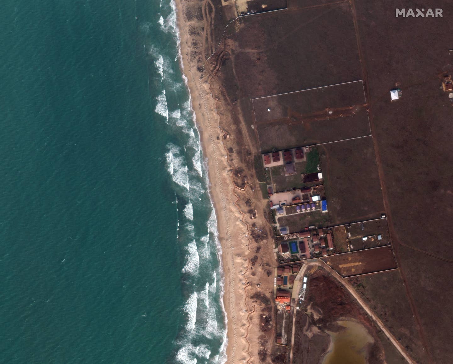 The Russians have built dragon's teeth and trenches along the beach west of Yevpatoria, Crimea. Satellite image ©2023 Maxar Technologies.