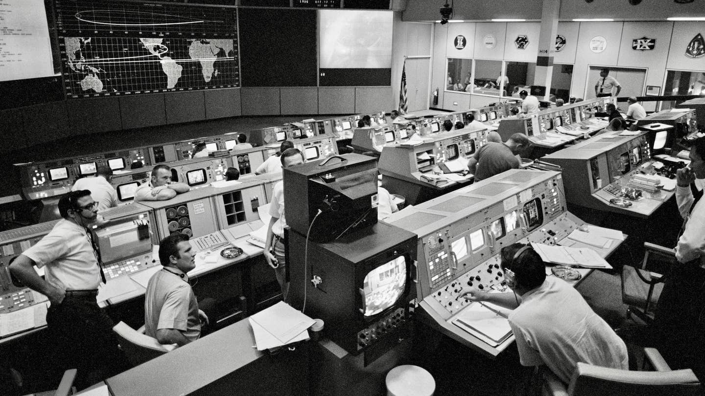 Mission Operations Control Room (MOCR) activities during Apollo 11's re-entry on July 24, 1969. NASA