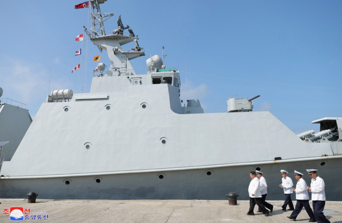 One of the two turrets for the six-barrel 14.5mm machine guns is seen immediately forward of the bridge. <em>KCNA</em>