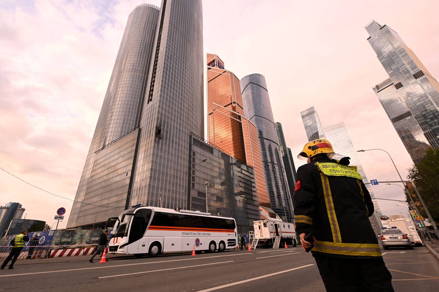 A rescuer stands next to a damaged building of the Moscow International Business Center (Moskva City) following a drone attack in Moscow on August 23, 2023. A Ukrainian drone attack on Moscow damaged a building in a central business district, authorities said on August 23, in the sixth straight night of aerial attacks on Russia's capital region. (Photo by NATALIA KOLESNIKOVA/AFP via Getty Images)