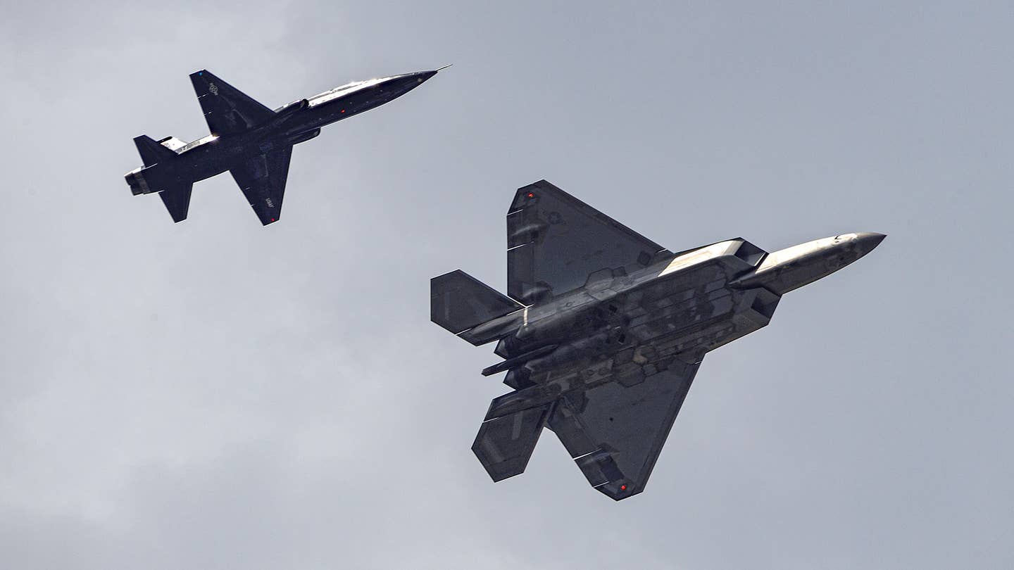 An F-22 returns to Savannah/Hilton Head International Airport with a T-38A aggressor. <em>Jamie Hunter</em>