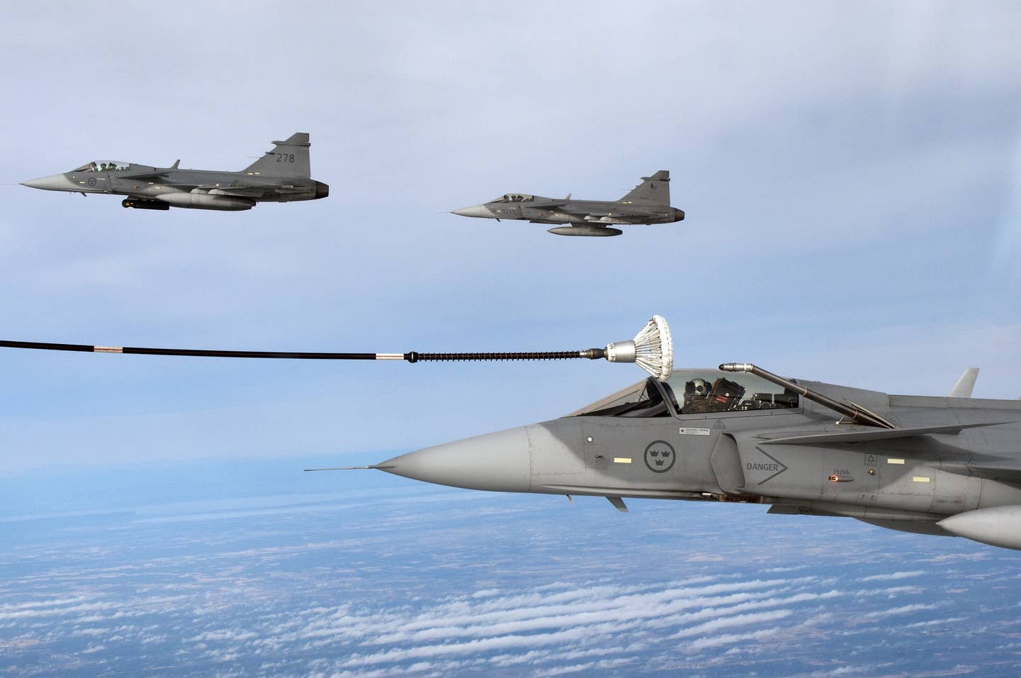 Saab JAS 39 of the Swedish Air Force undergoing inflight refueling from a TP 84 Hercules, February 2012. <em>Milan Nykodym via Wikimedia Commons, CC-BY-SA-2.0</em>