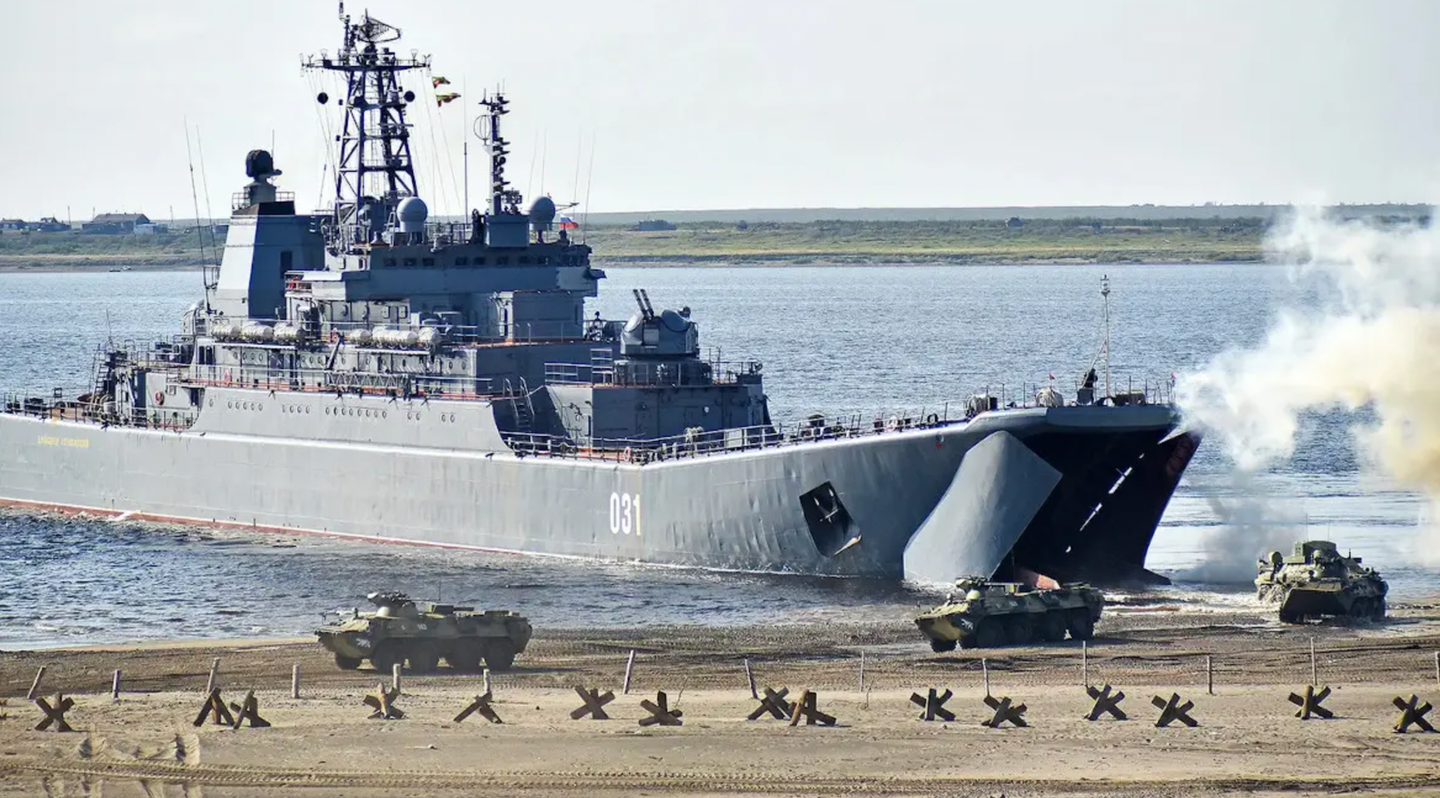 BTR-82 armored personnel carriers disembark from a <em>Ropucha</em> class landing ship during an exercise. <em>DENIS KOZHEVNIKOV/TASS VIA GETTY IMAGES</em>