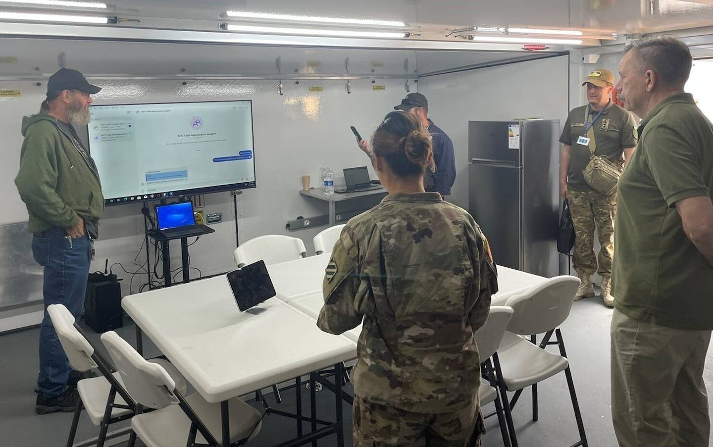 Deputy Minister of Defense of Ukraine Volodymyr Havrylov (right) receives a briefing at the 405th Army Field Support Brigade’s Tele-Maintenance and Distribution Cell-Ukraine in Jasionka, Poland, July 17, 2023. <em>U.S. Army </em>