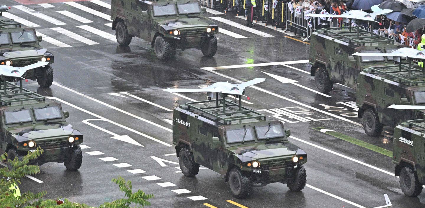 South Korean flying wing drones on top of Kia Light Tactical Vehicles (KLTV) on parade in Seoul. <em>ANTHONY WALLACE/AFP via Getty Images</em>