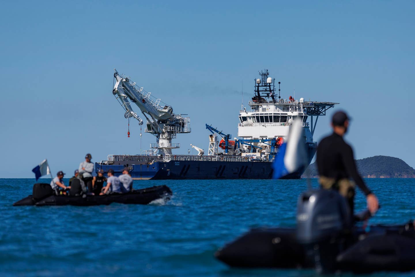 Royal Australian Navy clearance divers conduct diving operations alongside the auxiliary ship Australian Defence Vessel <em>Reliant</em> during the MRH90 Taipan recovery, in the vicinity of Lindeman Island, on August 13, 2023. <em>COMMONWEALTH OF AUSTRALIA, DEPARTMENT OF DEFENSE</em>