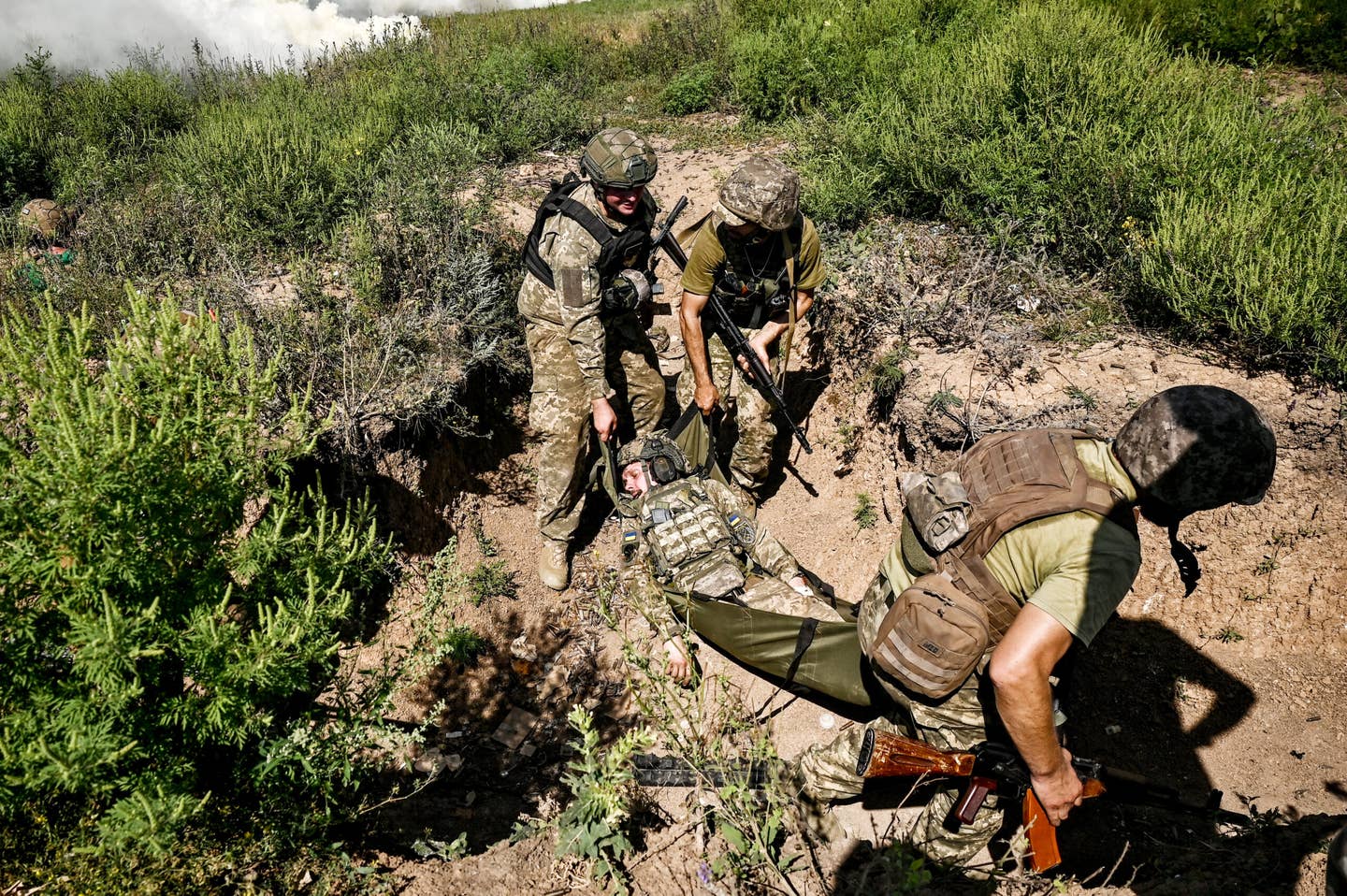 Servicemen of the 128th Separate Brigade of the Territorial Defense Forces apply first aid skills as they practice storming enemy positions during a tactical drill in the Zaporizhzhia direction, southeastern Ukraine. <em>Dmytro Smolienko / Ukrinform/Future Publishing via Getty Images</em>