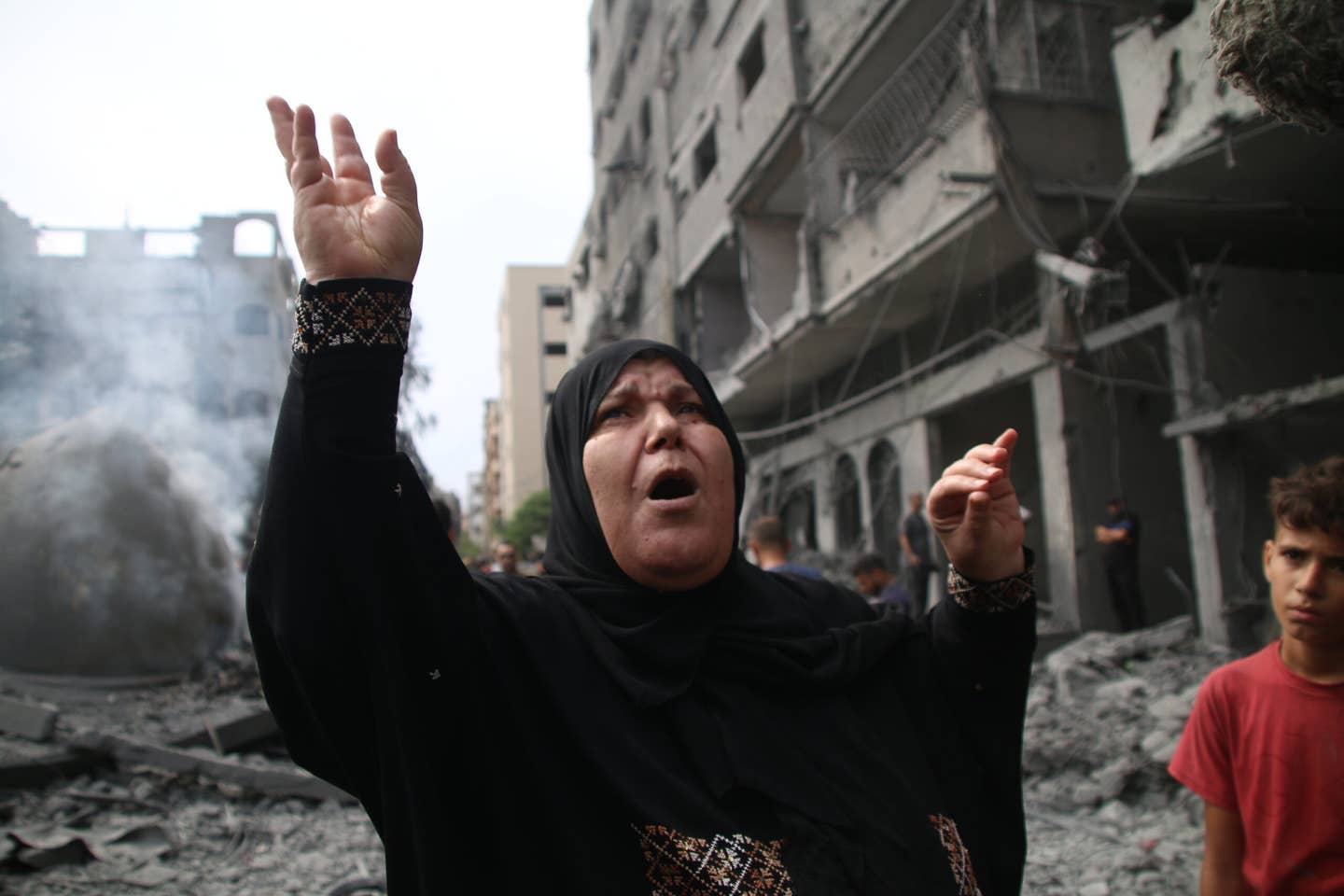 Palestinian citizens inspect the damage to the Al-Sussi Mosque and their homes following Israeli air strikes in the Al-Shati Palestinian refugee camp. (Photo by Ahmad Hasaballah/Getty Images)