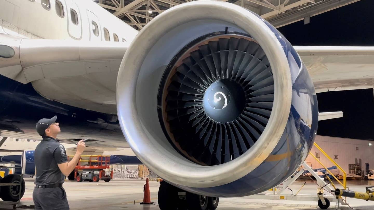 Delta Air Lines technician inspects a jet engine