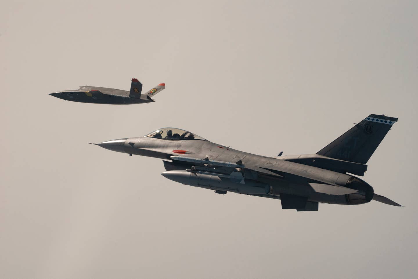 One of the US Marine Corps' two XQ-58A Valkyrie drones flies together with a US Air Force F-16C Viper fighter on October 3, 2023. <em>USAF</em>