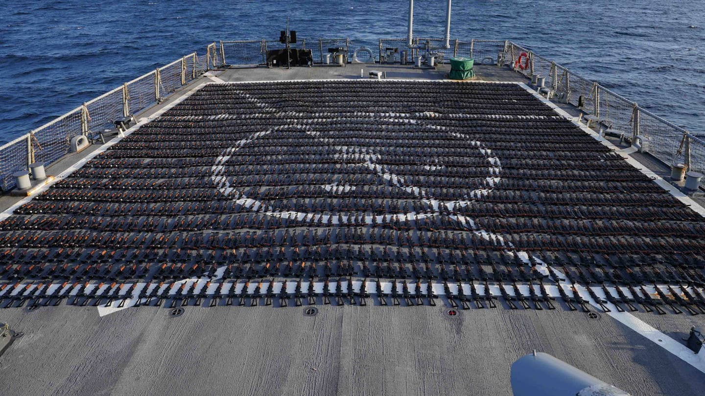 Guns that had been headed to Yemen from Iran that were captured during a counter-smuggling operation in the Gulf of Oman on January 6, 2023, are displayed on the stern flight deck of the U.S. Navy's <em>Arleigh Burke</em> class destroyer USS <em>The Sullivans</em>. <em>CENTCOM</em>