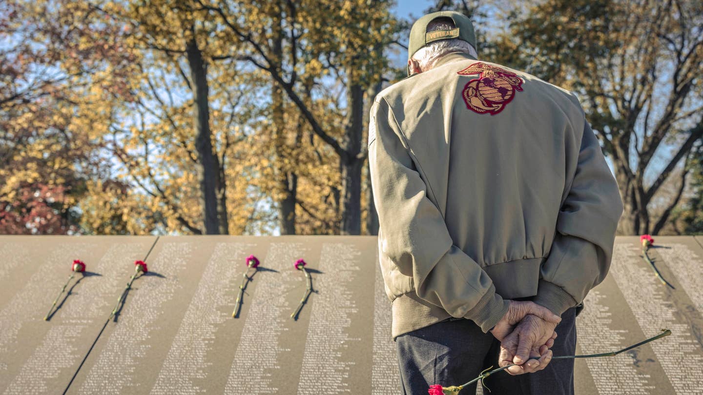 A U.S. Marine Corps Korean War veteran searches the names of those who lost their life during the Korean War at the Korean War Memorial during a reunion for those who fought at the Battle of the Chosin Reservoir in Washington, DC on Nov. 3, 2023. Veterans of the Battle of Chosin Reservoir, also known as The Chosin Few, traveled from across the country to meet with other Marines who fought by their side