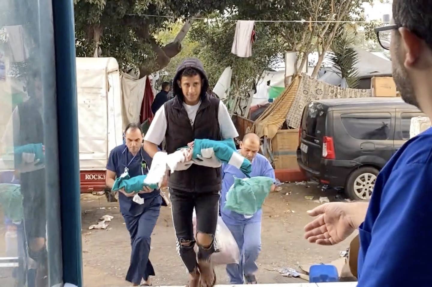 A screen grab captured from a video shows premature babies under treatment in the neonatal intensive care unit remove from the incubators and transferred to another department in the hospital after Israeli attack on Shifa Hospital in Gaza City, Gaza on November 14, 2023. (Photo by Palestinian Prime Ministry/Anadolu via Getty Images)