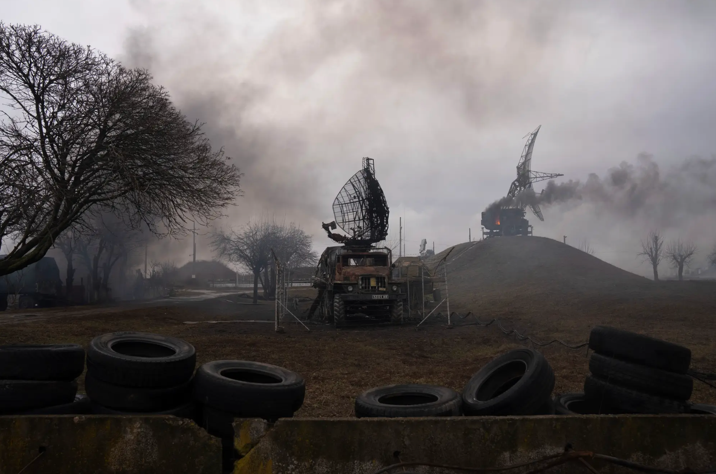 Smoke rises from an air defense site in the aftermath of an apparent Russian strike in Mariupol, Ukraine, on the first day of the conflict. <em>AP Photo/Evgeniy Maloletka</em>