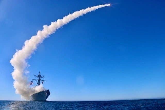 The guided-missile destroyer USS<em> Chafee</em> (DDG 90) launches a Block V Tomahawk, the weapon’s newest variant, during a three-day missile exercise in December 2020. This event marked the first time a Block V Tomahawk missile was operationally tested. <em>U.S. Navy photo by Ens. Sean Ianno/Released</em>