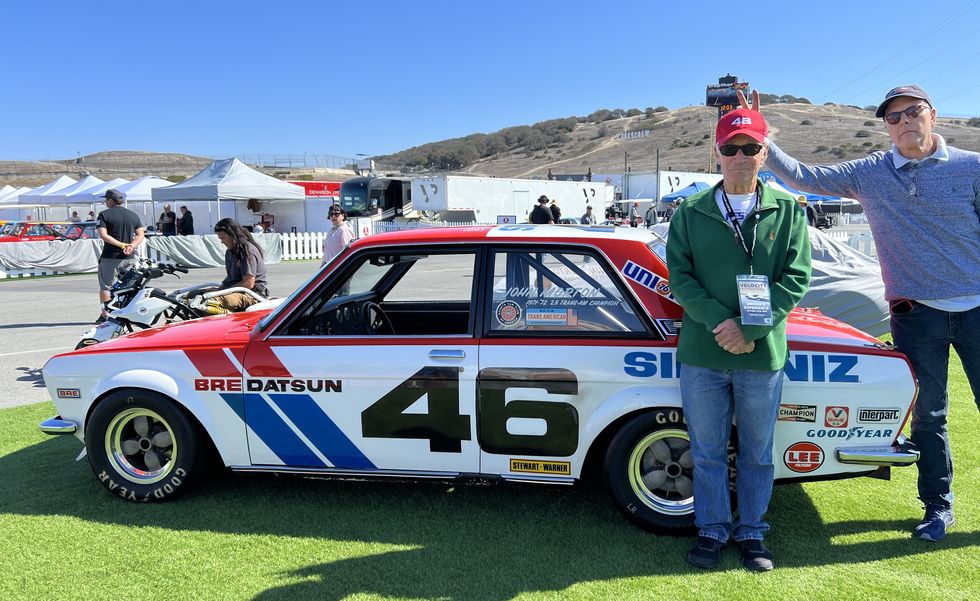 john morton gets bunny ears from a friend next to a datsun