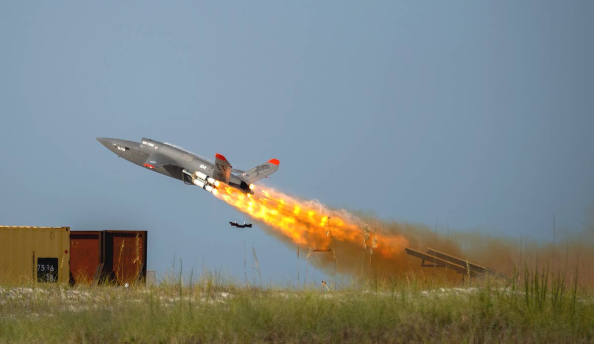 A US Air Force XQ-58A Valkyrie being launched with the help of rocket boosters. <em>USAF</em>