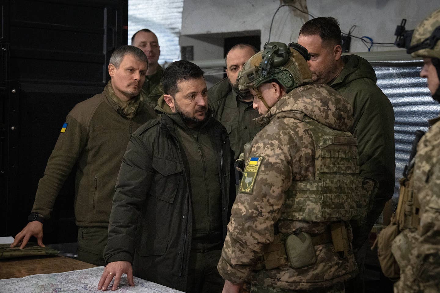 Ukrainian President Volodymyr Zelensky talks to the commander of Ukraine's ground forces, Col.-Gen. Oleksandr Syrsky during a visit to the front-line city of Kupiansk, Kharkiv region, Ukraine, Thursday, Nov. 30, 2023. Behind them left to right are: Roman Mashovets, deputy head of the Presidential Office, Defense Minister Rustem Umerov center, and Head of the Presidential Office Andriy Yermak. (AP Photo/Efrem Lukatsky)