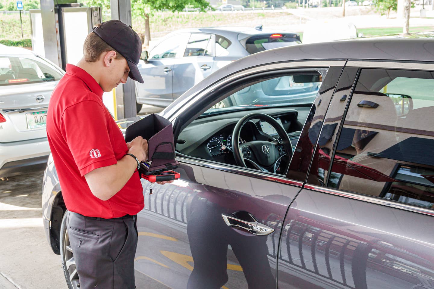 A Chick-Fil-A employee takes an order on a tablet in Georgia