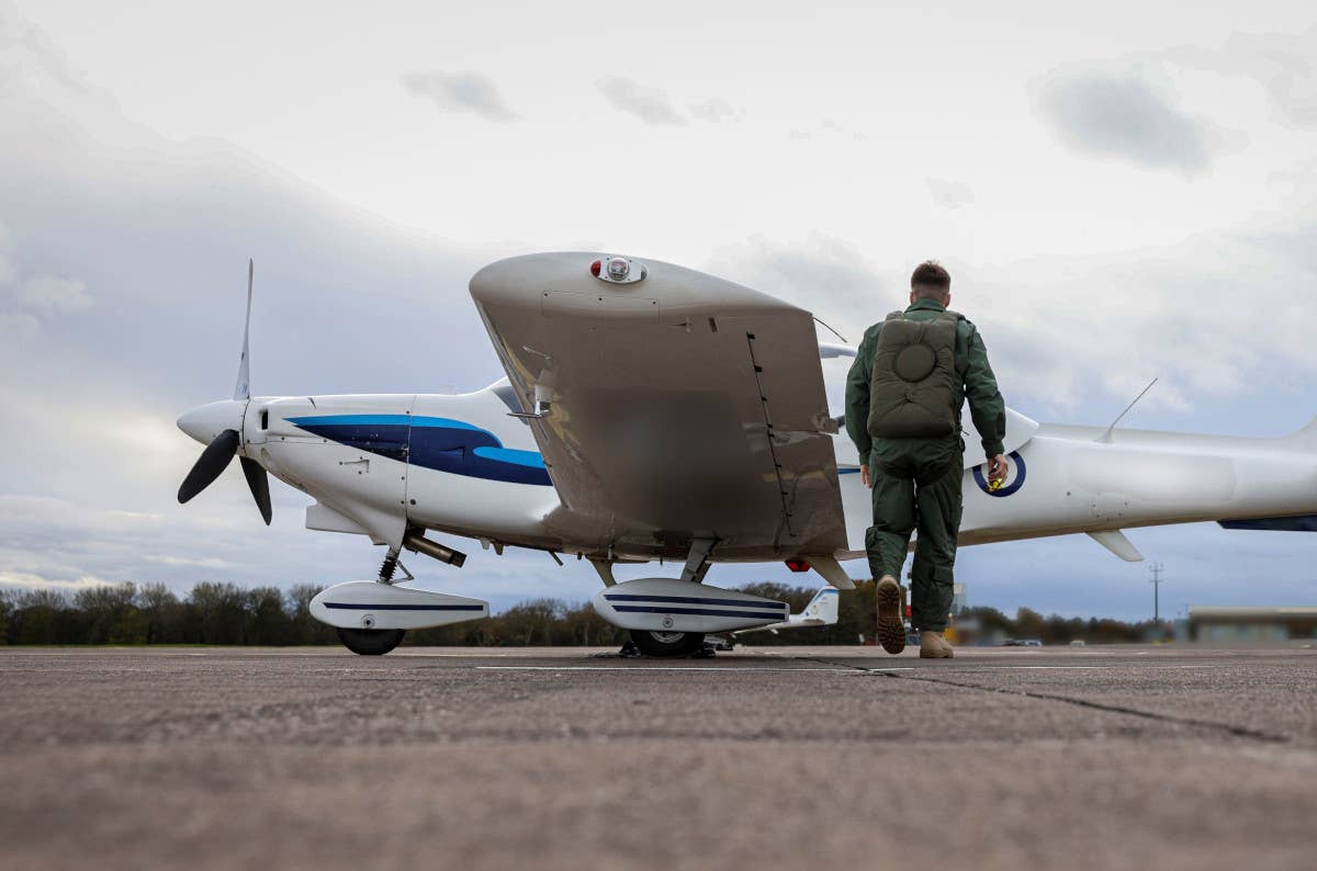 A Ukrainian pilot prepares to get into an RAF Grob Tutor T1 trainer as part of a training program in the United Kingdom. <em>Crown Copyright</em>