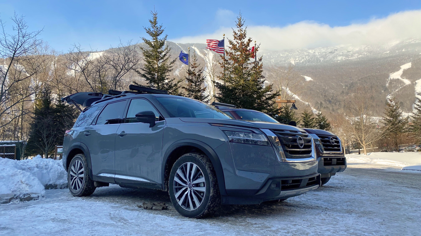 gray car in front of trees and mountains