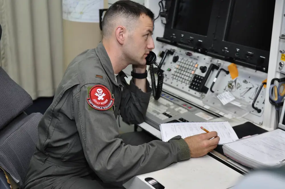 Second Lieutenant Adam Pauley, 320th Missile Squadron deputy combat crew commander, communicates over the phone during a Simulated Electronic Launch-Minuteman test inside a launch control center at a missile alert facility in the 90th Missile Wing missile complex, Aug. 21, 2018. Accomplishing the SELM validates these claims and increases the deterrent capability of the Minuteman III ICBM weapon system. (U.S. Air Force photo by Senior Airman Breanna Carter) 