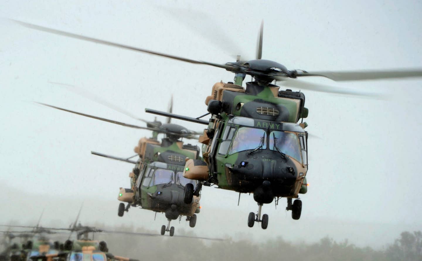 Australian Army 5th Aviation Regiment NH-90s lift off during an Air Mobility exercise at Townsville Field Training Area during an Australian Army 3rd Brigade Combined Arms Training Activity. <em>Commonwealth of Australia, Department of Defense</em>