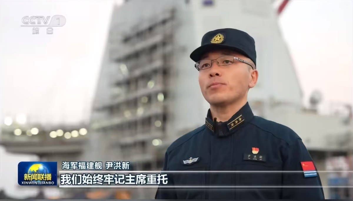 Scaffolding seen about <em>Fujian</em>'s island. CCTV screencap