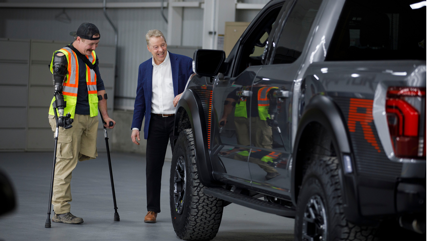 two men next to a ford truck