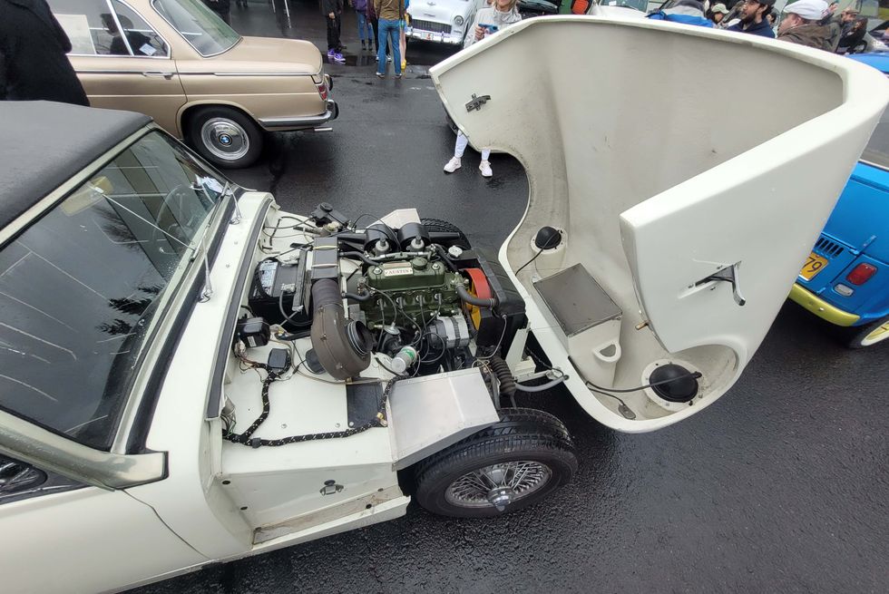 a car with an open clamshell hood