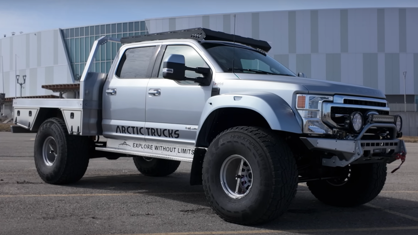 large silver truck on giant wheels